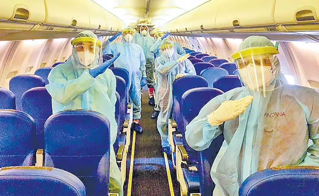 Cabin Crew Attire of Indian Airlines to Include Face Shield and gown - Sakshi