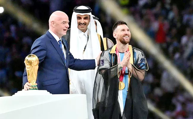 Lionel Messi Wearing Black Coat Huge Price Lifted FIFA WC Trophy Qatar - Sakshi