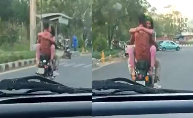 Couple Seen Romancing On Moving Bike After Celebrating Holi Jaipur - Sakshi