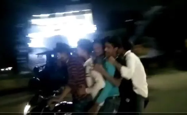 Viral Video Uttar Pradesh Five Youths Seen Riding Bike on Busy Road - Sakshi