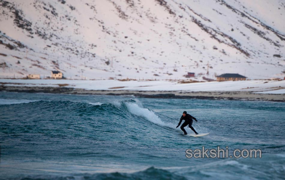 A surfer looks at the Northern lights6