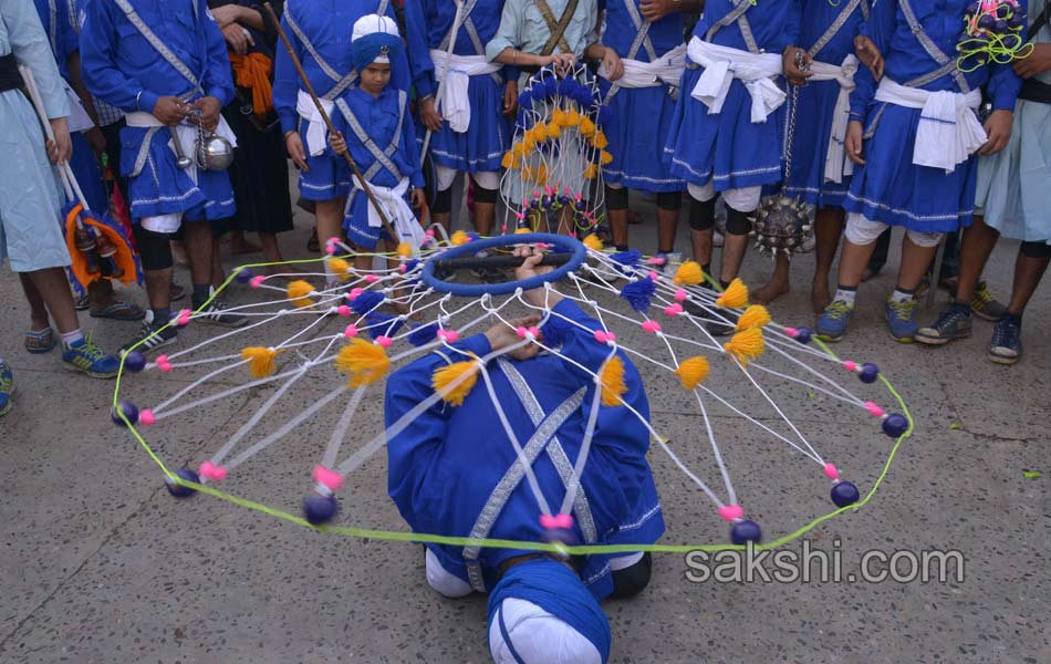 Sikh priest sits behind the Guru Granth Sahib6