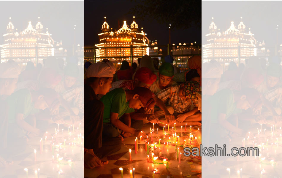 Sikh priest sits behind the Guru Granth Sahib12