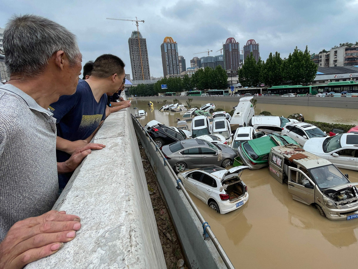 Heavy rainfall floods streets and subway stations in China Photo Gallery - Sakshi2