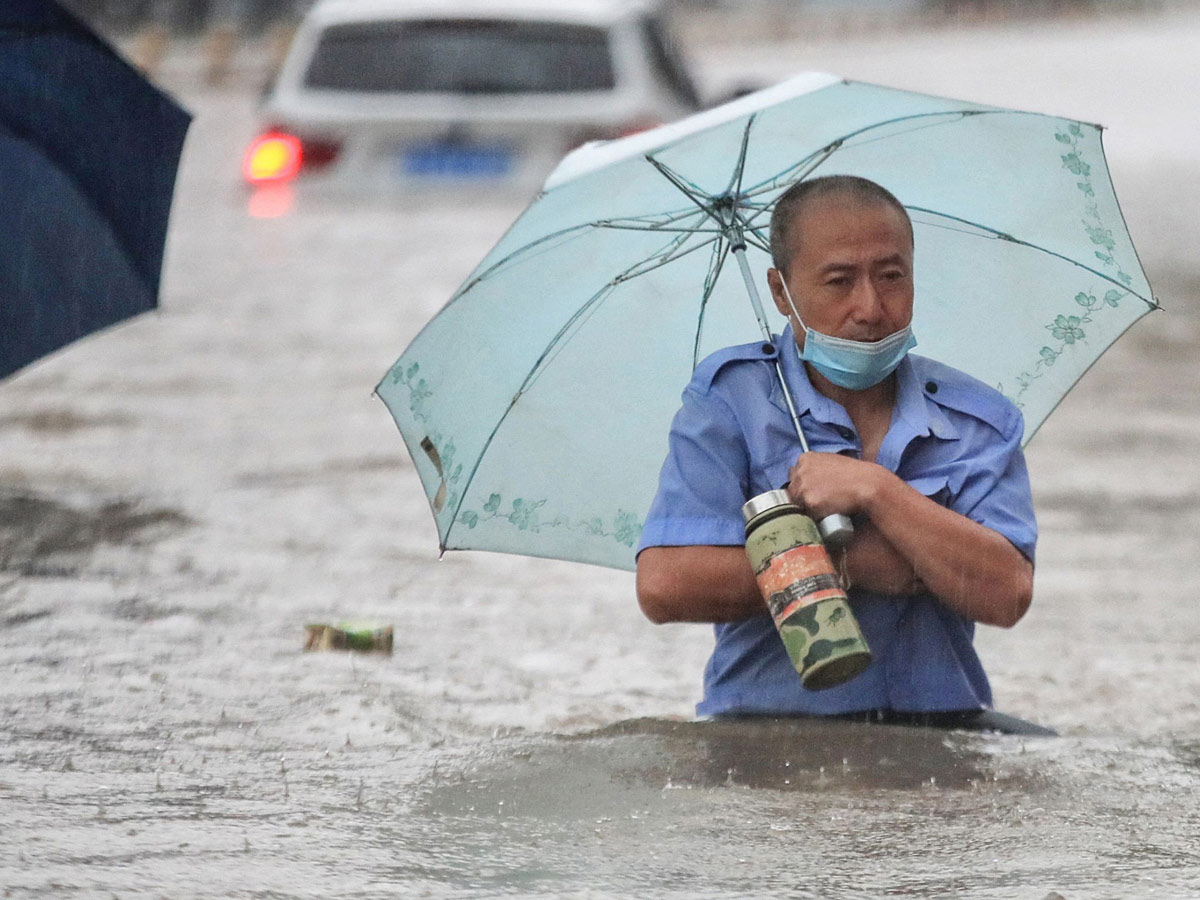 Heavy rainfall floods streets and subway stations in China Photo Gallery - Sakshi11