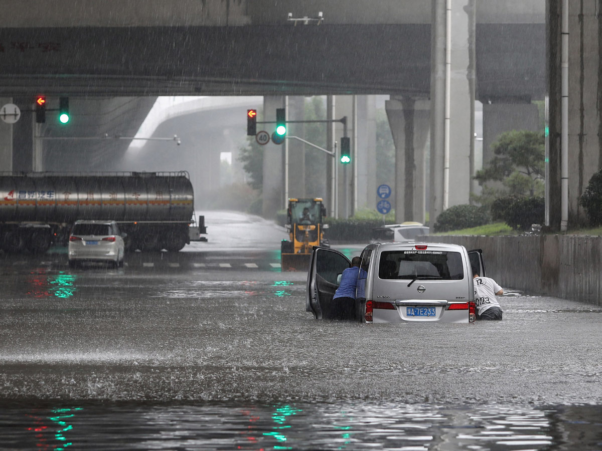 Heavy rainfall floods streets and subway stations in China Photo Gallery - Sakshi12