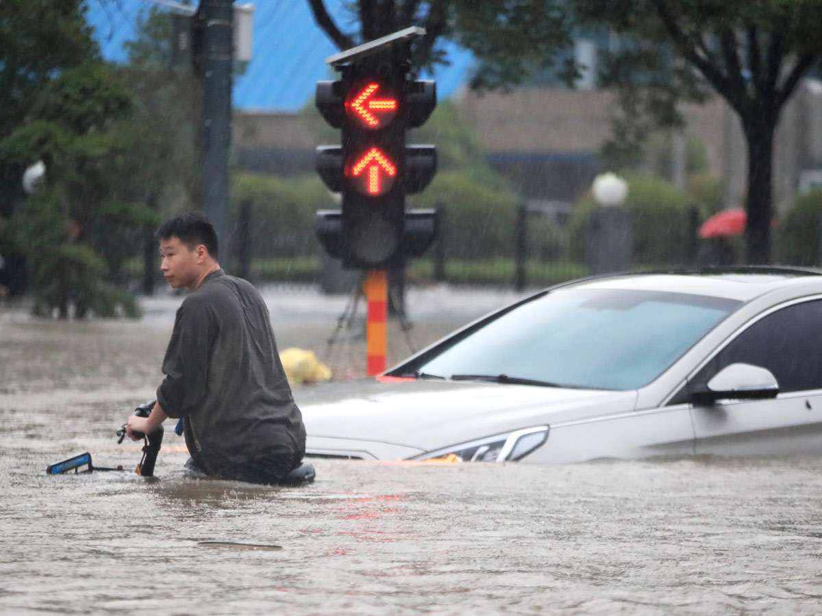 Heavy rainfall floods streets and subway stations in China Photo Gallery - Sakshi1