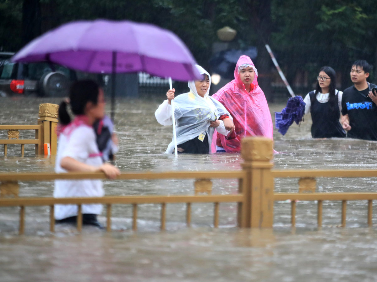 Heavy rainfall floods streets and subway stations in China Photo Gallery - Sakshi13