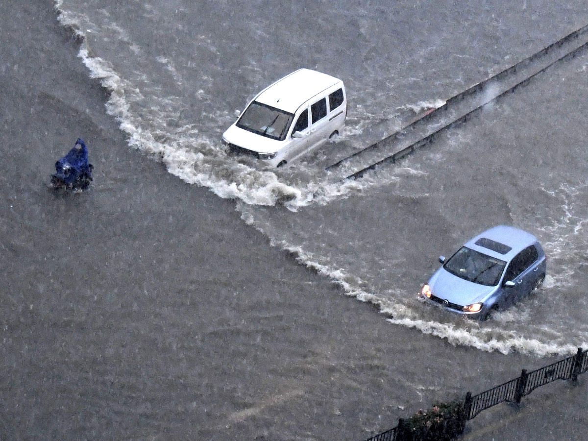 Heavy rainfall floods streets and subway stations in China Photo Gallery - Sakshi14