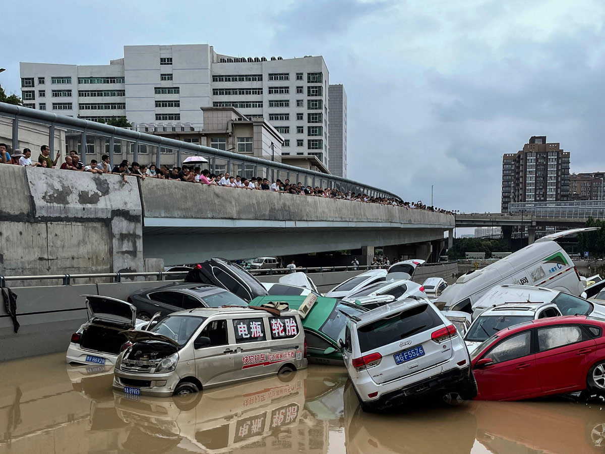 Heavy rainfall floods streets and subway stations in China Photo Gallery - Sakshi4