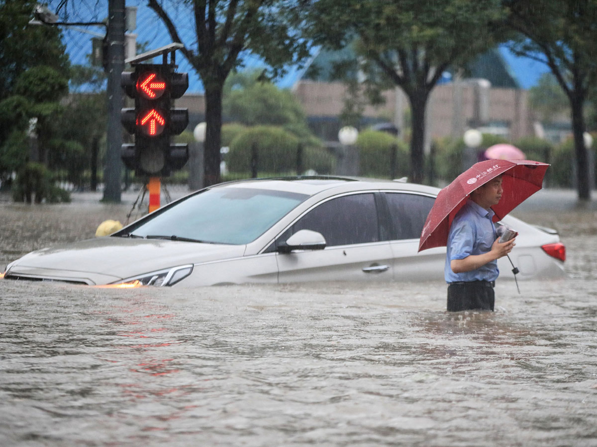 Heavy rainfall floods streets and subway stations in China Photo Gallery - Sakshi9