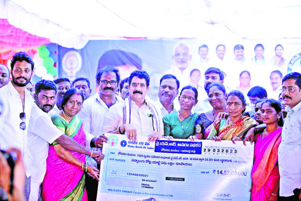 చోడవరం సభలో డ్వాక్రా మహిళలకు ఆసరా చెక్కు అందజేస్తున్న ప్రభుత్వ విప్ కరణం ధర్మశ్రీ 1