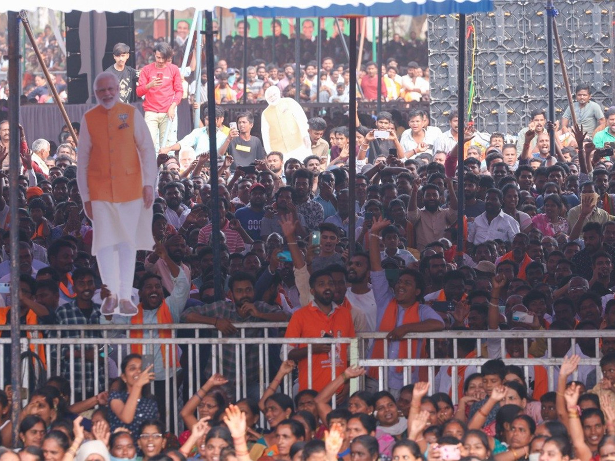 Narendra Modi greets supporters as he arrives for an election campaign rally - Sakshi14