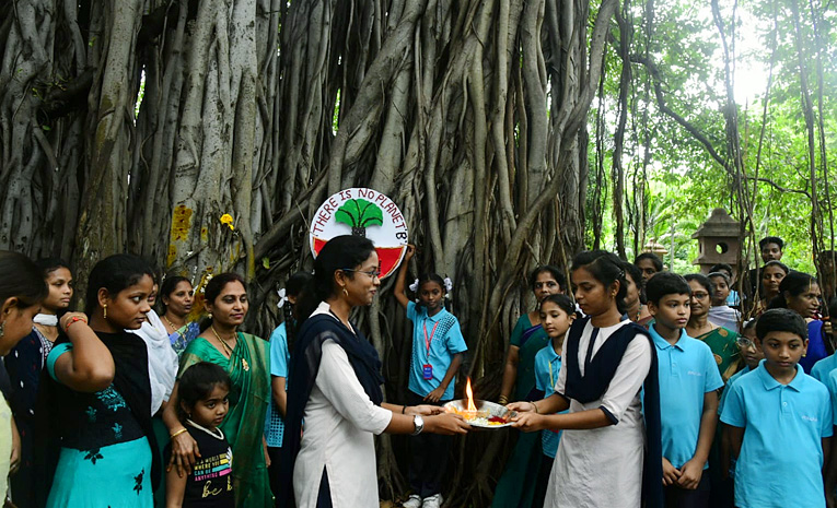 Students tie Rakhi to hundred years of history old banyan tree in Visakhapatnam Photos6