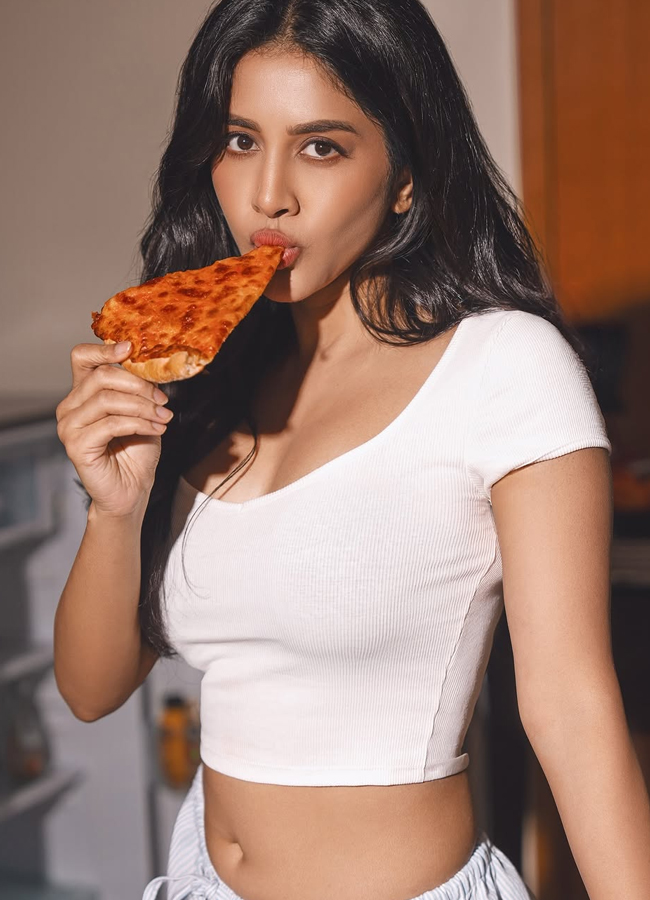 Nabha Natesh is eating pizza in a white skirt11
