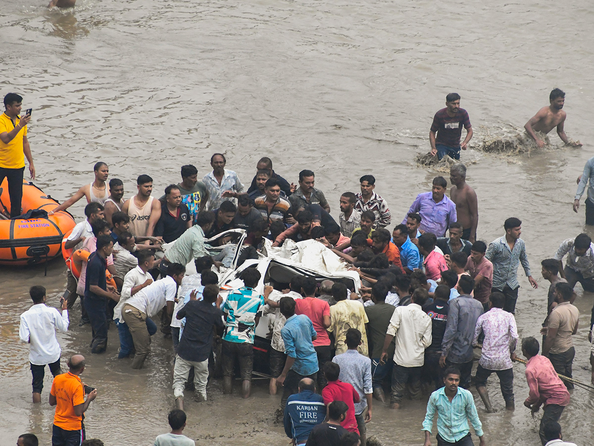 river following the collapse of a portion of a bridge in Mujpur near Vadodara 11