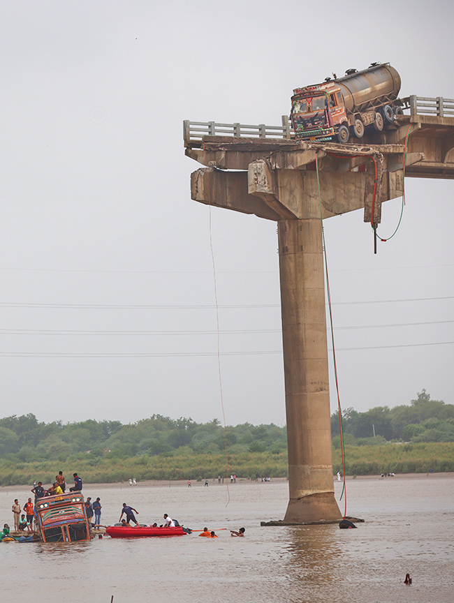 river following the collapse of a portion of a bridge in Mujpur near Vadodara 4