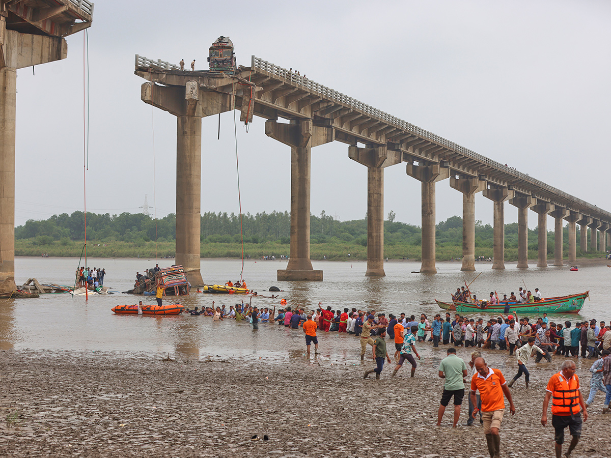 river following the collapse of a portion of a bridge in Mujpur near Vadodara 7