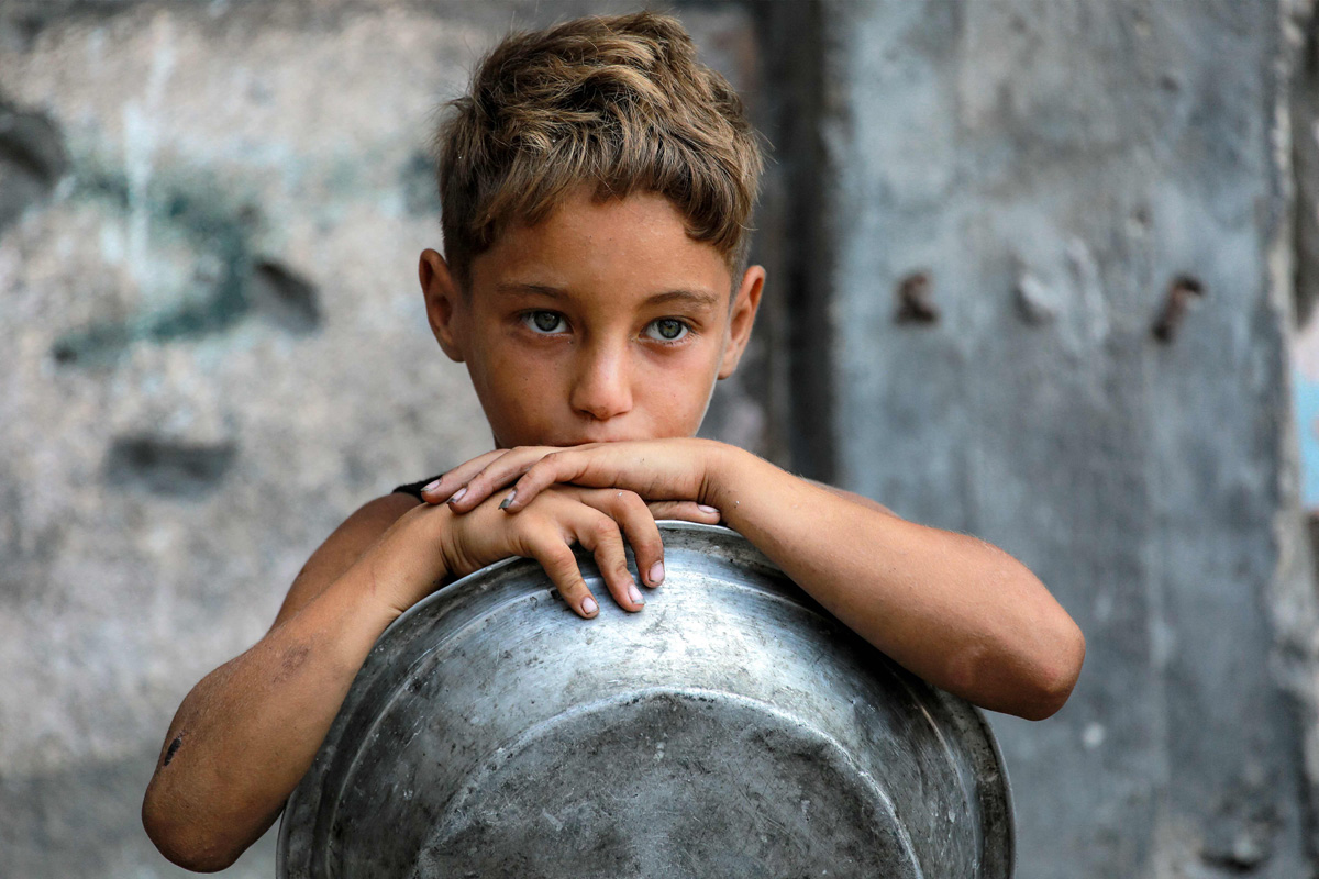 Palestinians wait for donated food at a community kitchen in Gaza City5