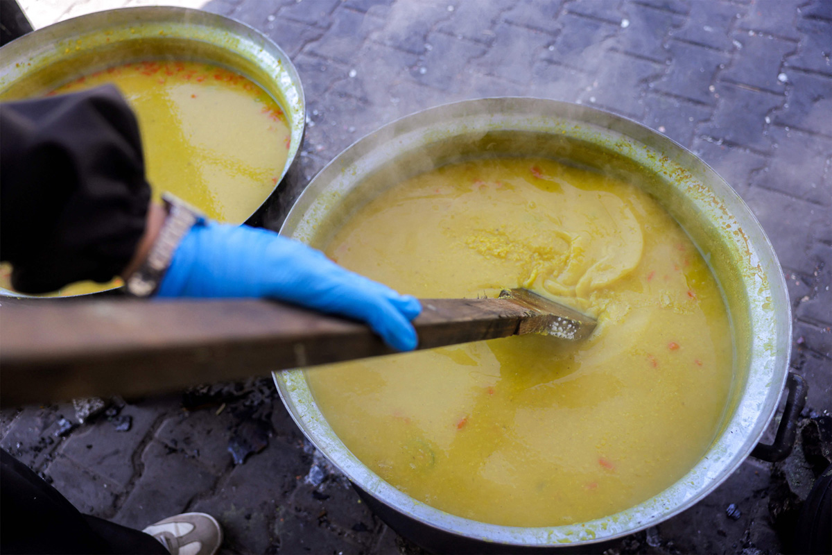 Palestinians wait for donated food at a community kitchen in Gaza City8