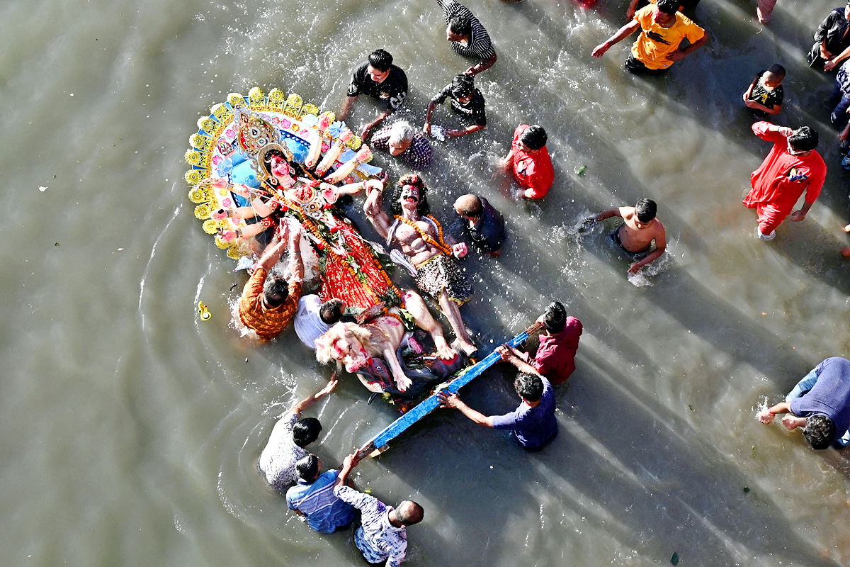 Devi Durga Being Immersed In Ganga River - Sakshi