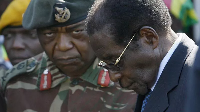 Military seizes power to stop 'criminals' taking over as Robert Mugabe held 'for own safety' - Sakshi