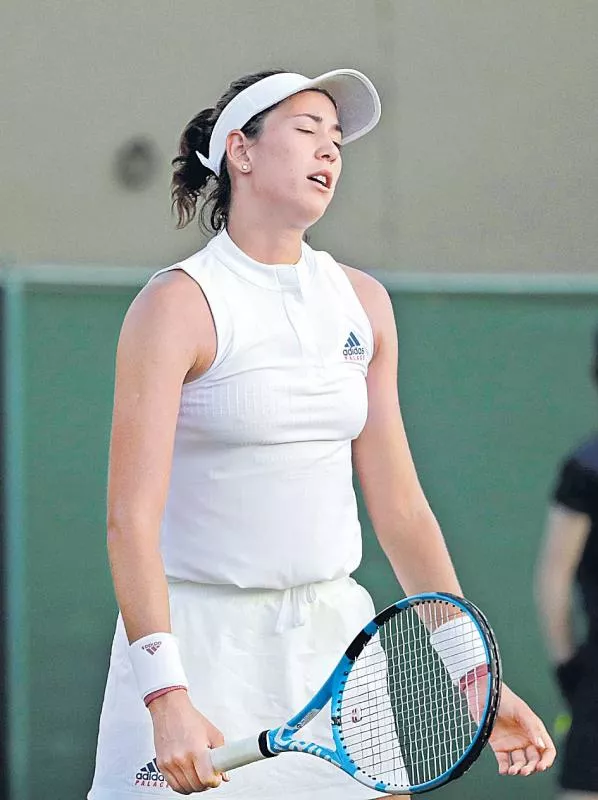 Defending champion Muguruza out of Wimbledon as seeds scatter - Sakshi