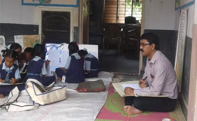 The Headmaster Sitting on the Floor and Giving Lessons - Sakshi