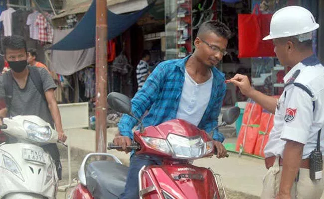 Manipur cops give sweets to people riding without helmet  - Sakshi
