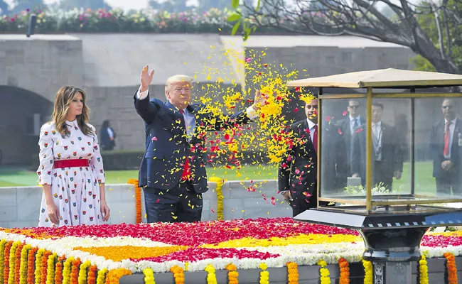 Donald Trump pays tribute to Mahatma Gandhi at Sabarmati Ashram - Sakshi
