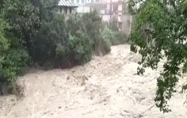 Heavy Rains In Uttarakhand And Rivers Flowing Above Danger Level - Sakshi