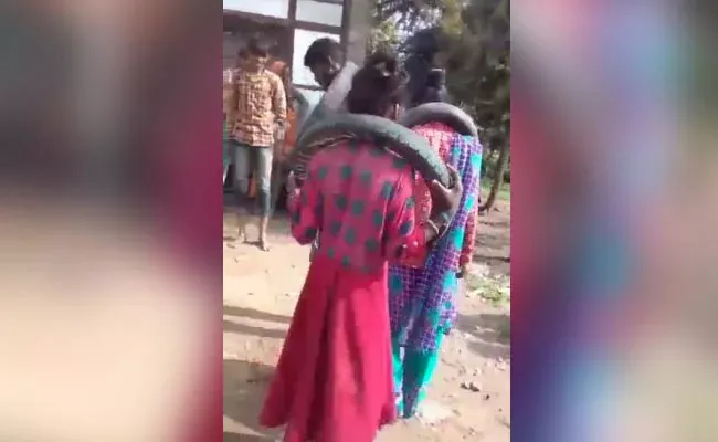 Madhya Pradesh Couple Forced To Dance With Tire Around Neck For Eloping - Sakshi