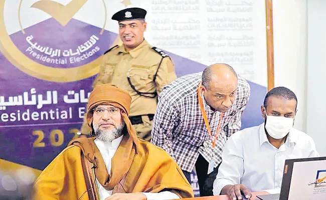 Gaddafi son Seif al-Islam registers to run for Libya presidency - Sakshi