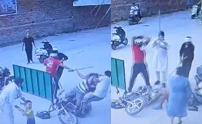 Men Thrash Father With Sticks In Front Of Crying Son  - Sakshi