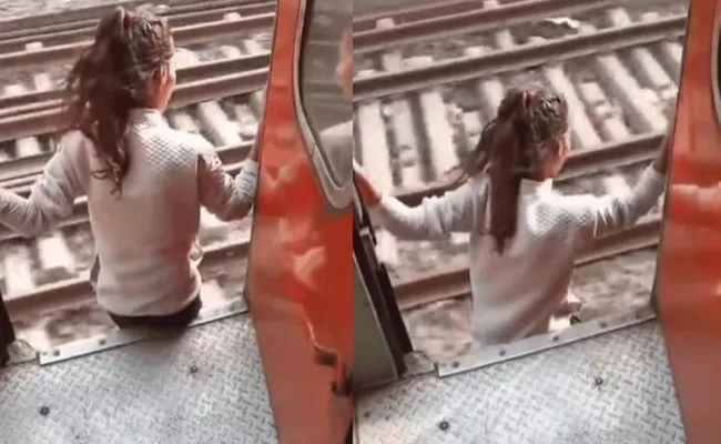 Girl jumps from a running train video goes viral - Sakshi
