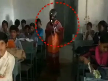 Govt teachers teach lessons with helmet in medak dist
