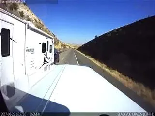 Horrific moment an RV camper loses control and sways dangerously before flipping and crashing