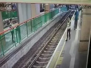 Man pushes woman on rail track