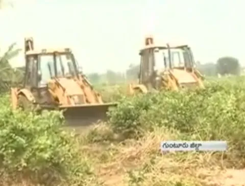 CRDA Officers damaged fields in Nidamarru - Sakshi