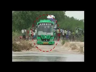 Rtc Bus Stuck In Flood Water in kurnool district - Sakshi
