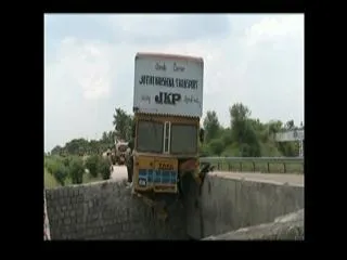 container hits divider in palam - Sakshi