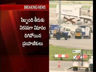 Passengers protest Indigo staff behaviour, staying still late at Airport - Sakshi