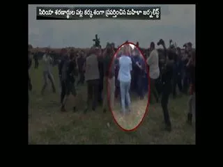 Journalist fired after being caught on camera kicking migrants - Sakshi