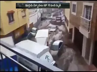 Flash floods sweep vehicles along Spanish street - Sakshi