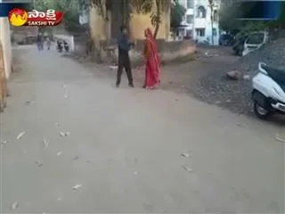 a woman chasing a man with a slipper in her hand and video goes viral - Sakshi