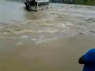 Shocking! Bus overloaded with passengers swept away by flash flood - Sakshi