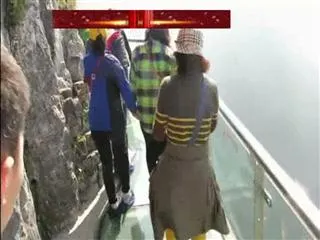 China's cliff-clinging glass skywalk opens to public - Sakshi