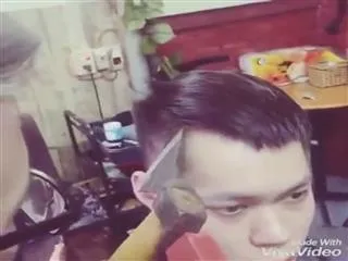hair cut with axe, shocking video shared in social media - Sakshi