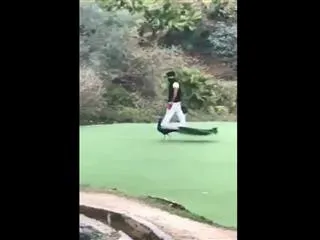 Ram Charan playing with peacock - Sakshi