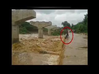 young man caught in flood safety in ranga reddy musi river - Sakshi